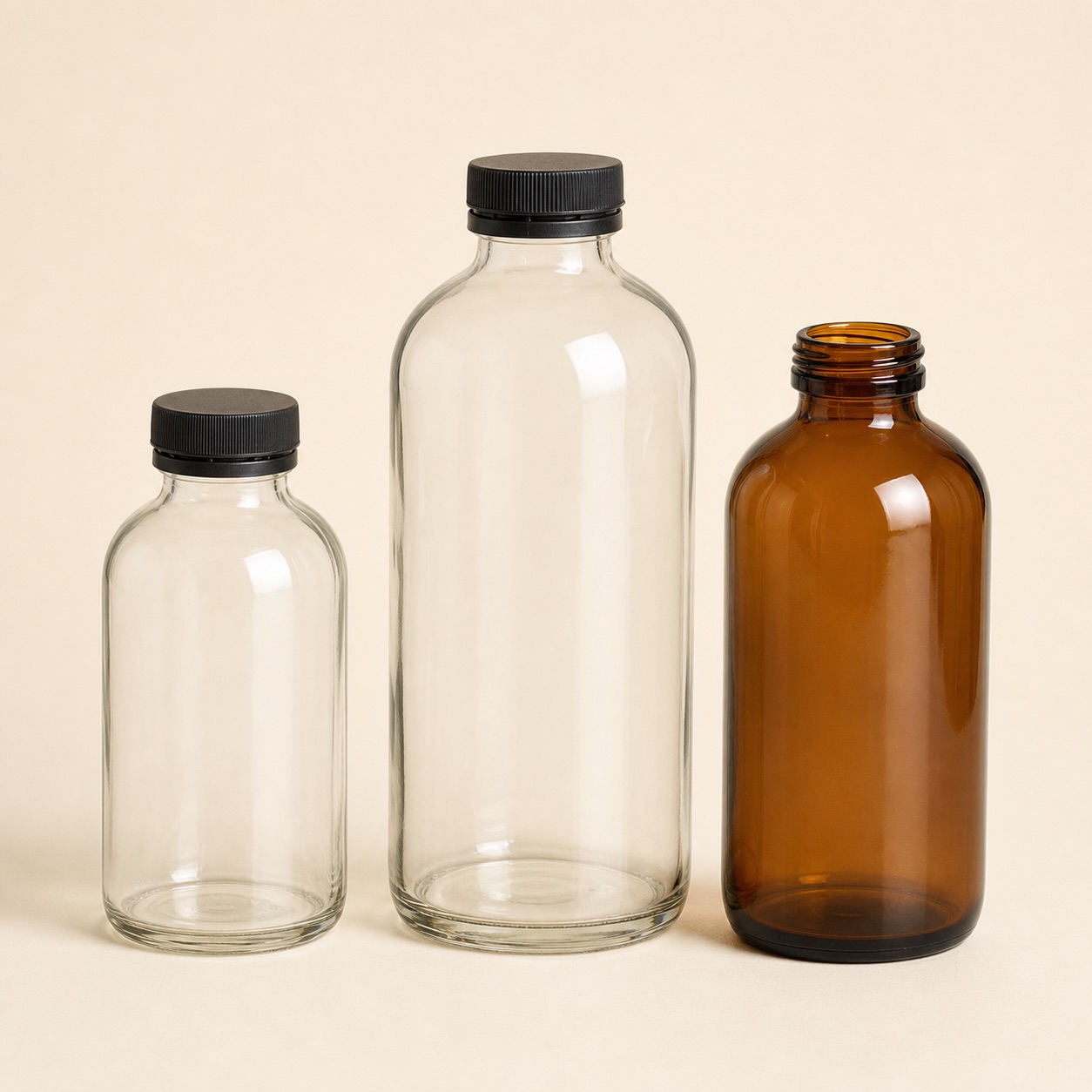 Unbranded wide-mouth clear and amber glass kombucha bottles